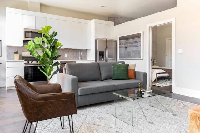 A living room in Sonder Greektown featuring a couch, coffee table, and plant.