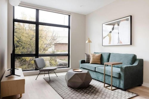 Sonder The Edison living room with a couch, chair, and a window.