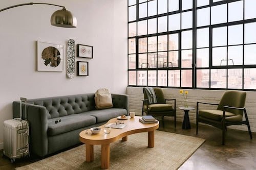 Sonder The Heid living room with a couch, coffee table, and a window.