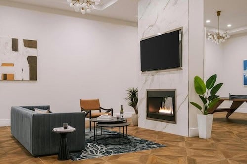 Sonder The Witherspoon living room with a fireplace, couches, and a TV.