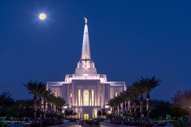 The Harvest Moon hangs low in the sky over the Latter-day Saints temple in Gilbert, just before sunrise.